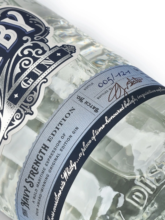 Navy Strength Gin, a bottle of gin sitting on a white plain surface