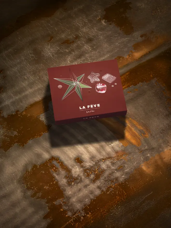 Dark red chocolate box packaging with festive graphics