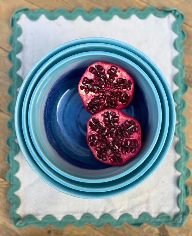 Landscape Serving Bowls (Set Of 3), a collection of colourful serving bowls on a table. They are accompanied by some fruits. 