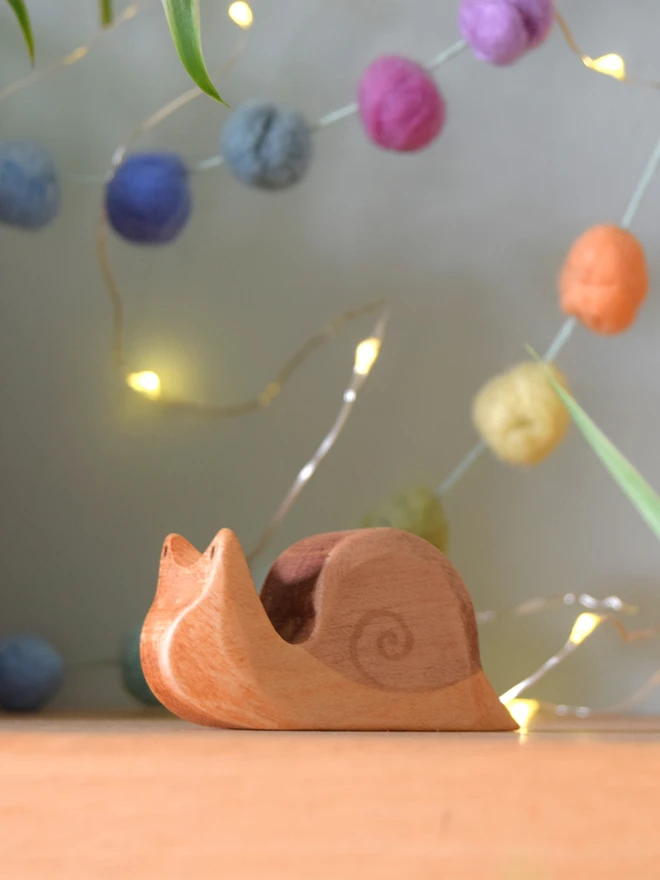 Handmade ecofriendly wooden toy figurines, snail toy figure sat on shelf  made by hand by Eric and Albert made in Wales, UK