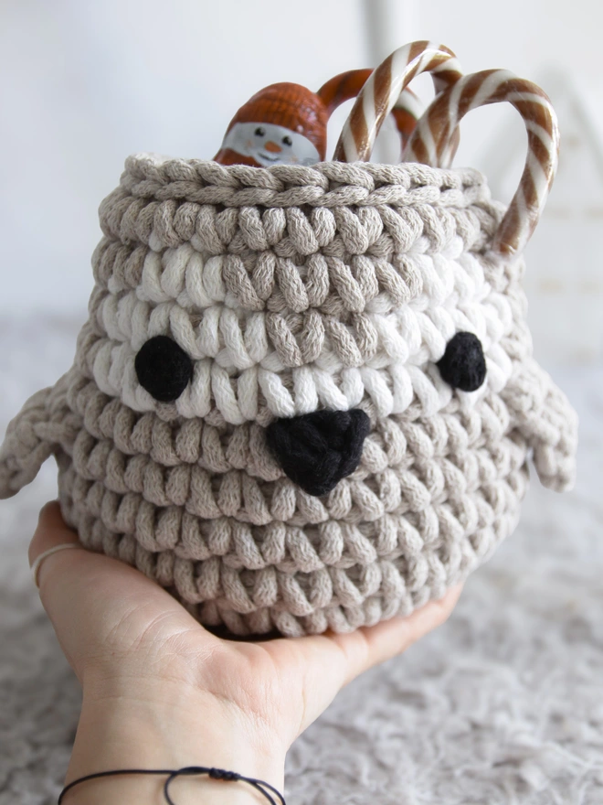 crochet penguin basket filled with sweets