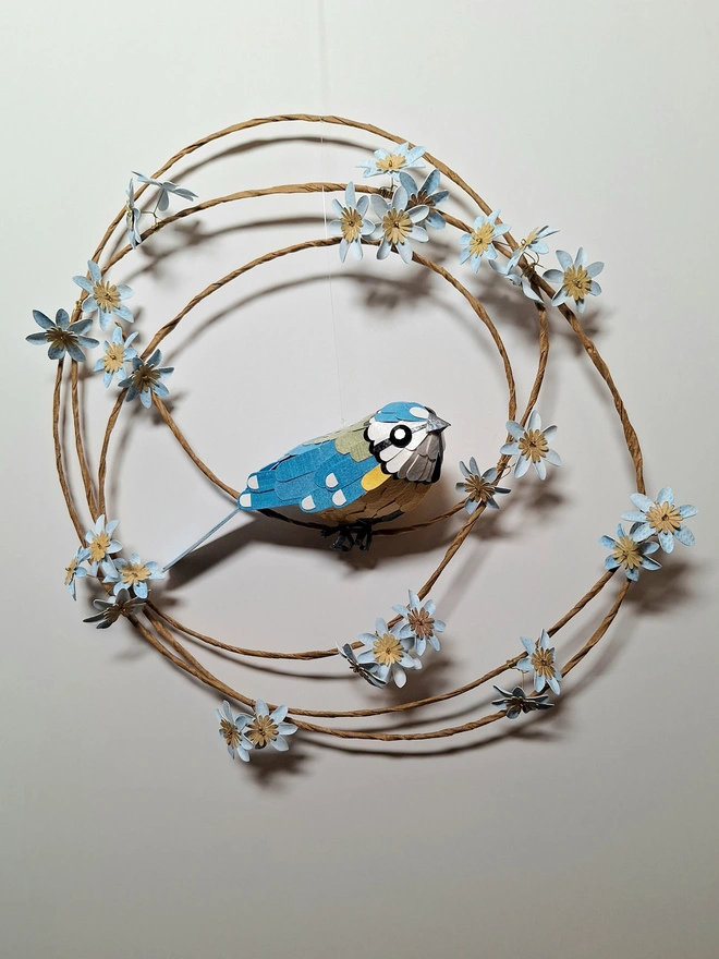 Blue Tit handmade wall sculpture on a wreath of blue flowers
