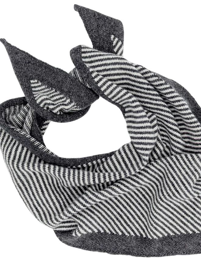 Lambswool Triangle Neck Scarf, a colourful neck scarf sitting on a white plain surface. 