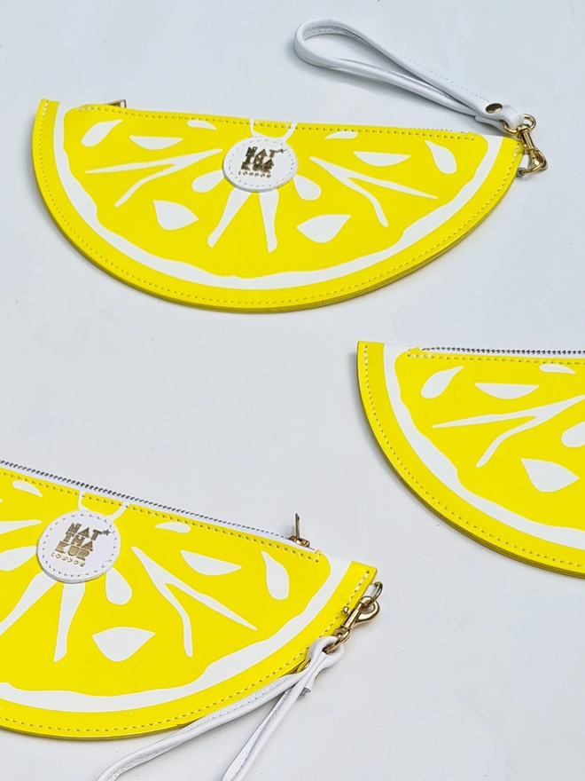 Leather lemon clutch bag by Natthakur