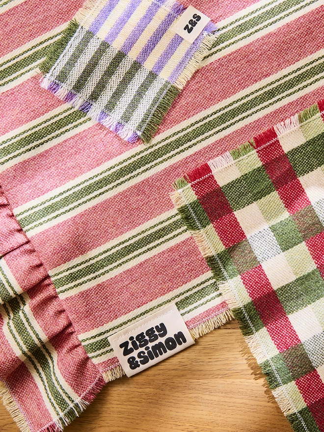 Parma Violet Coaster. Parma Violet Coaster laid on top of a Pink Sherbet Runner and paired with a Sour Apple Placemat. 