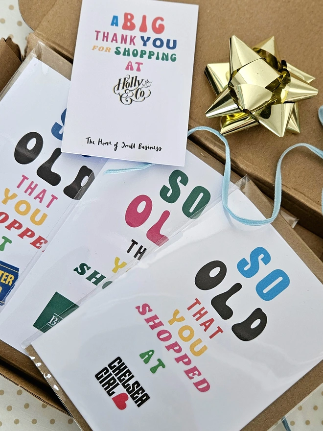 A photograph of a set of nostalgic shop cards in different designs in a box with a thank you card for shopping at Holly and Co