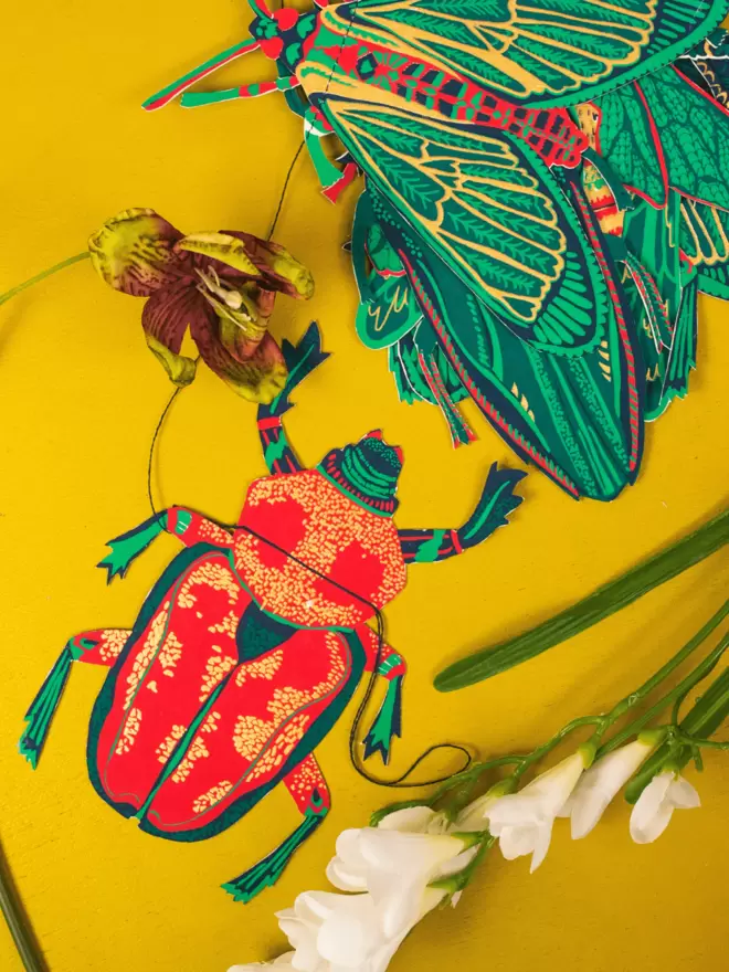 Red and gold scarab beetle decoration