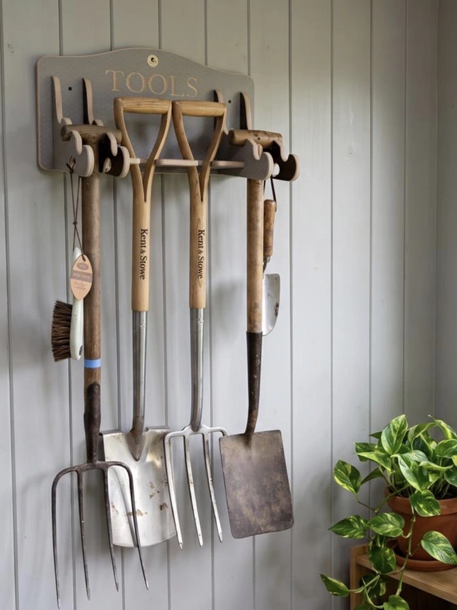 Grey garden tool storage hanger, hanging in a shed