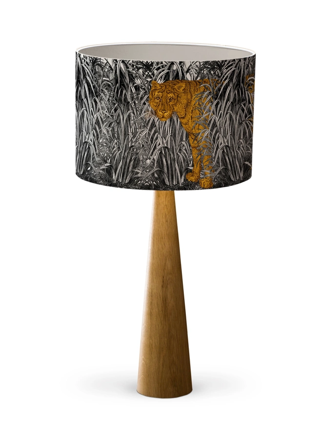 A decorative lampshade featuring an elegant tiger moving through tall tropical grasses, inspired by Henri Rousseau’s jungle paintings, with a rich botanical design.