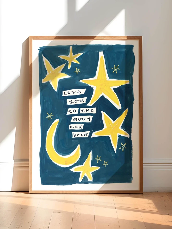 'love you to the moon and back' print. an art print with a blue background, yellow moons and stars and a slogan.