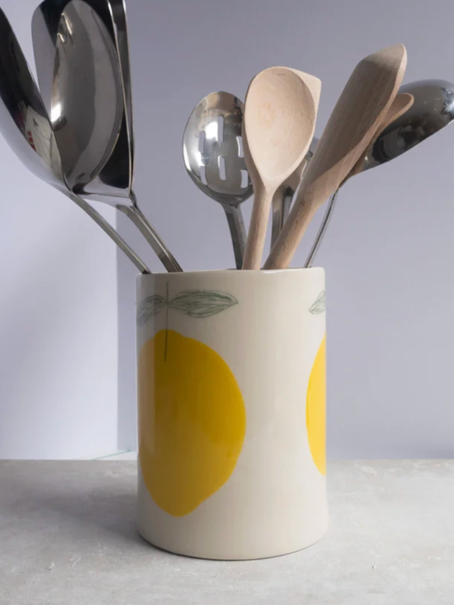 Utensil Holder. A utensil holder with a lemon design.