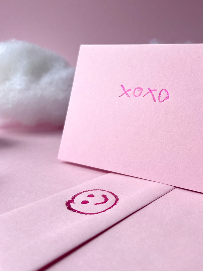 candy pink coloured card with xoxo hand foiled in kids hand writing