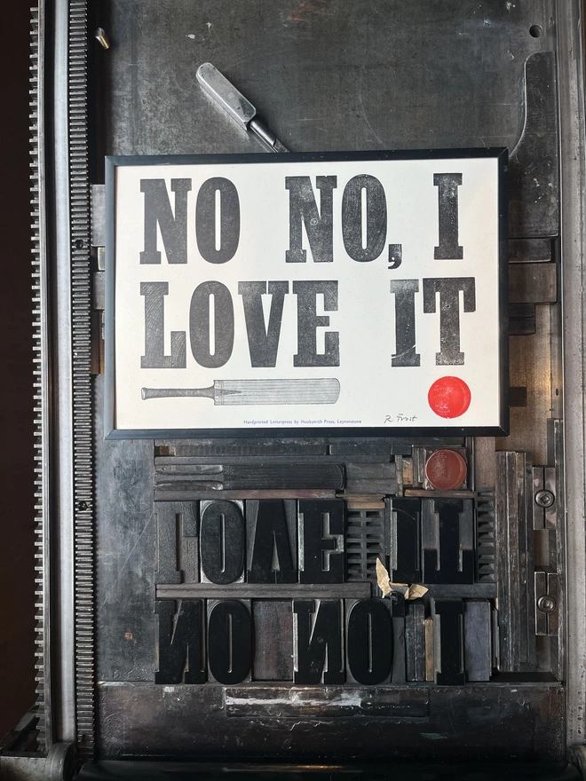 Letterpress print making in progress showing type setting on the bed of a Vandercook proofing press