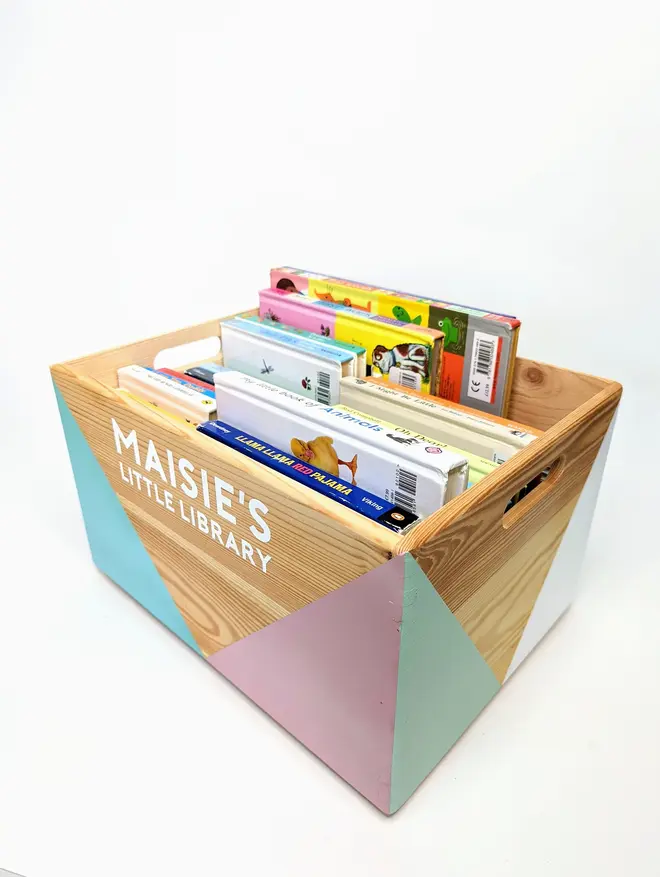 personalised kids' book storage box. a personalised wooden book box full of books.