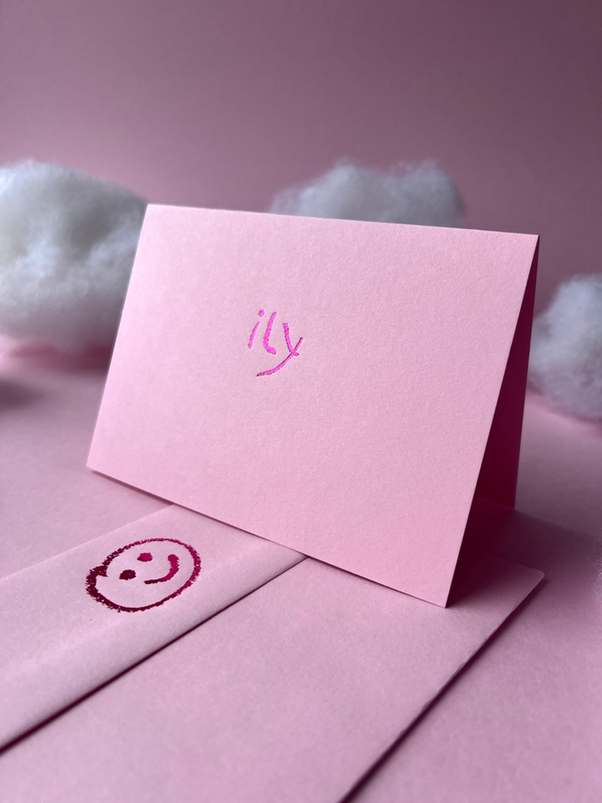 pastel pink coloured card with ily  short for 'I love you' hand foiled in kids hand writing