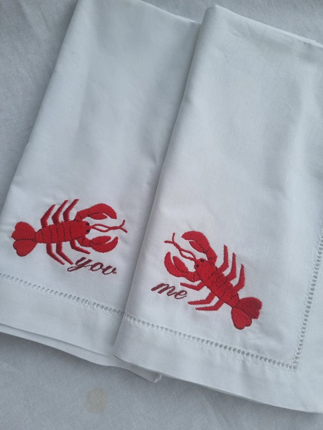 two white lobster napkins with me and you
