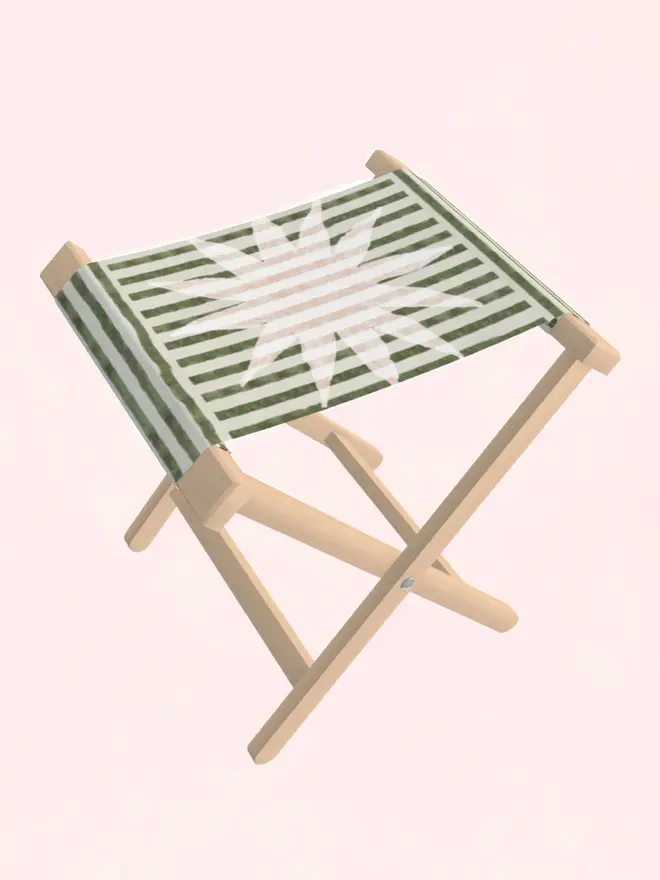 sun stripe folding stool. a green and white striped folding stool with a white sun motif.