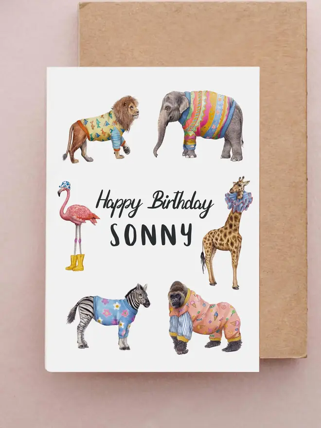 illustrated personalised children's birthday card. a white card featuring illustrated animals in party outfits. 