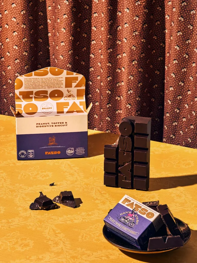 'NAN'S STASH' Peanuts, Toffee & Digestive Chocolate Bar open showing the chocolate on a table