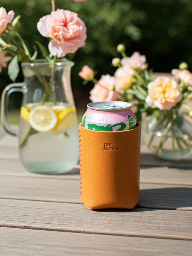yellow leather drinks sleeve on a garden table with fresh flowers