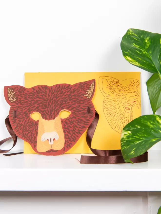 Full shot of image of brown bear head and matching envelope with an bear motif