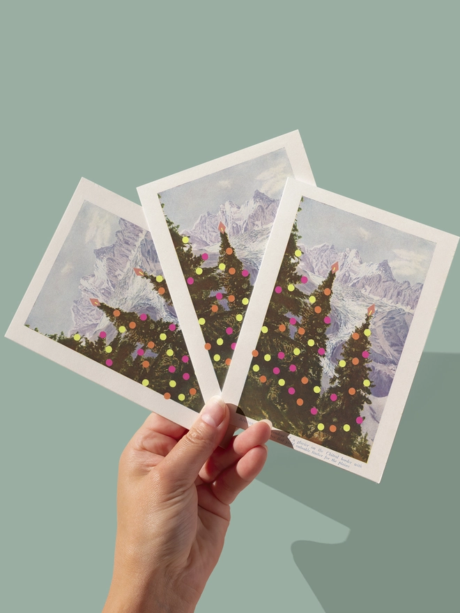 A vintage Christmas card with modern neon decorations and mountains in the distance.