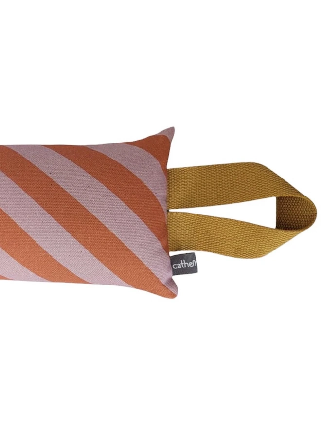 Draught Excluder, a colourful patterned draught excluder sitting on a white surface. 