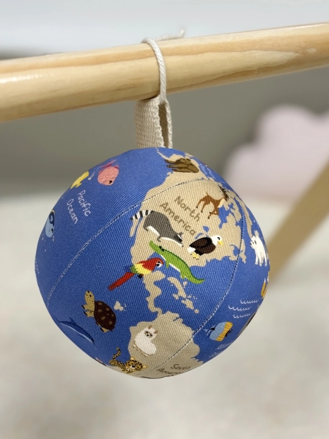 First globe soft toy featured as a hanging toy for a baby gym