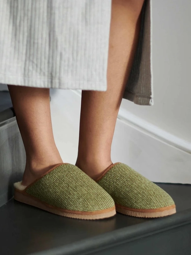 Lambswool & Sheepskin Slippers, a person wearing a pair of colourful lambswool and sheepskin slippers. 