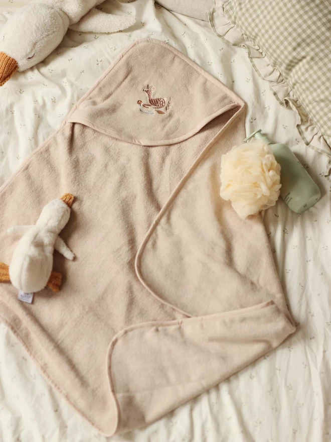 A cute hooded towel baby with plush duck