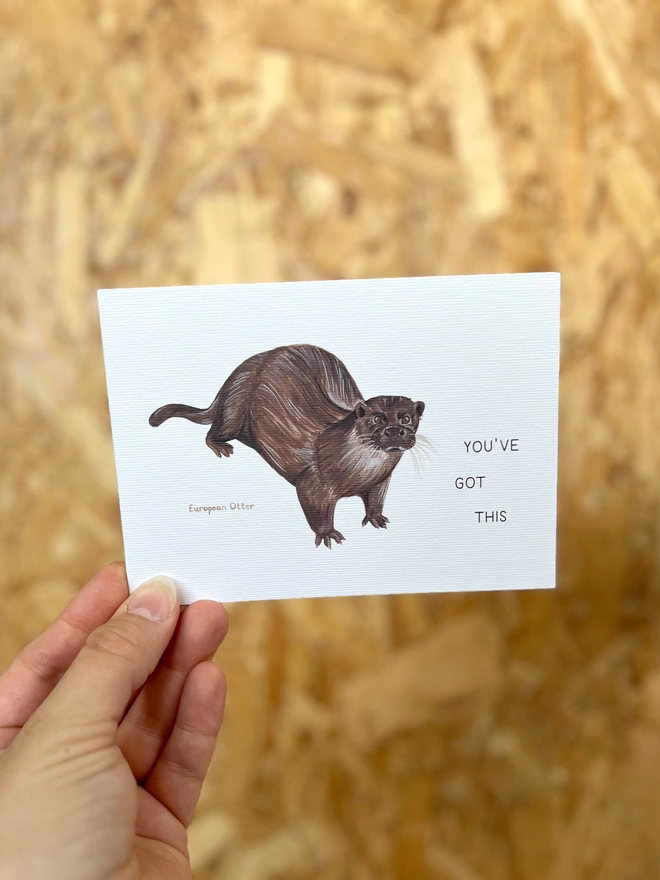 a greetings card featuring an illustration of an Otter with the text “You’ve Got This”