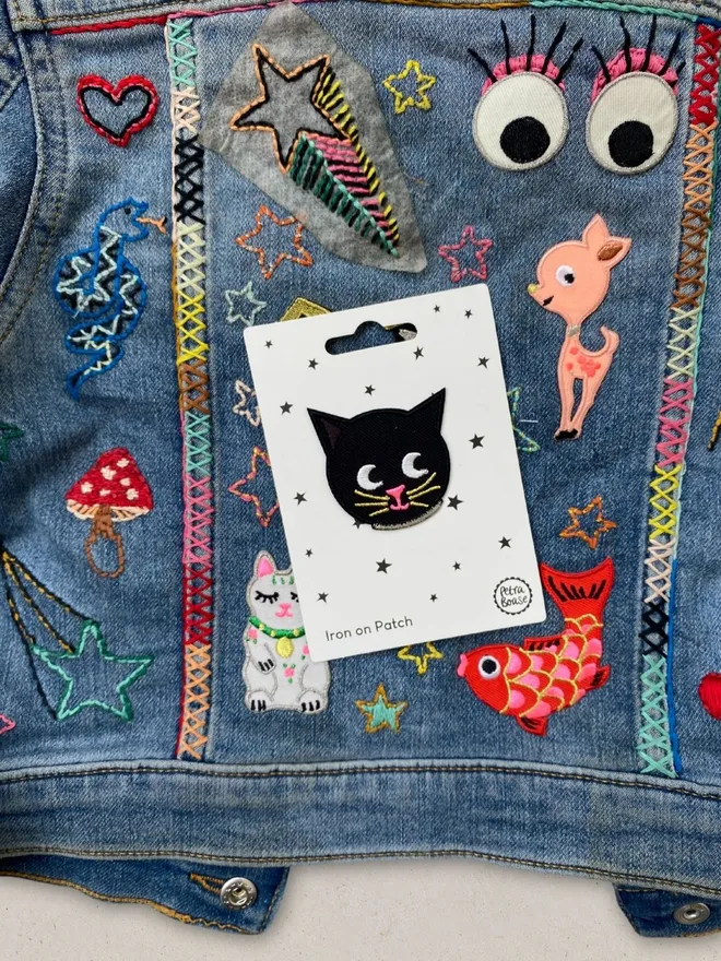 Cat face iron on patch on a kids embroidered customised denim jacket.