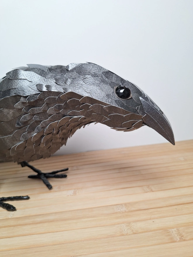 Edgar the raven, a close up of a handmade paper sculpture of a black bird