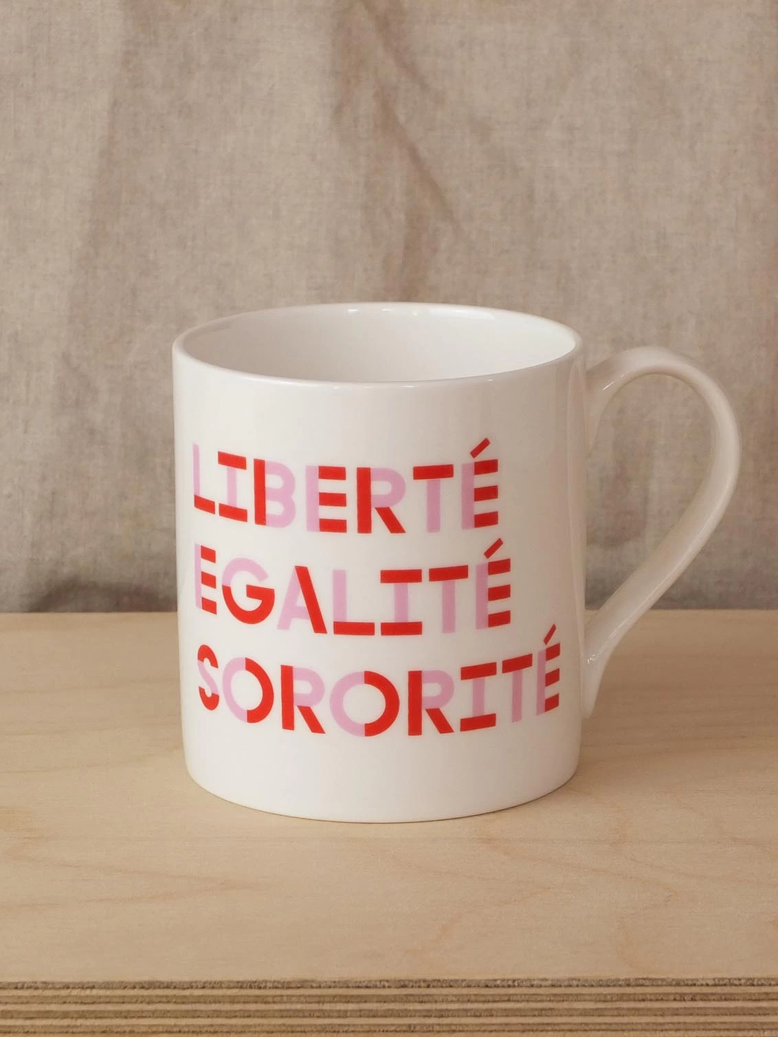 Black & Beech white mug with Liberte Egalite Sororite written on both sides in Pink and Red 