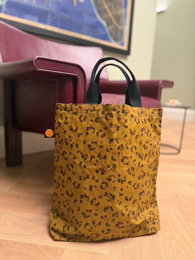 Leopard bag next to armchair
