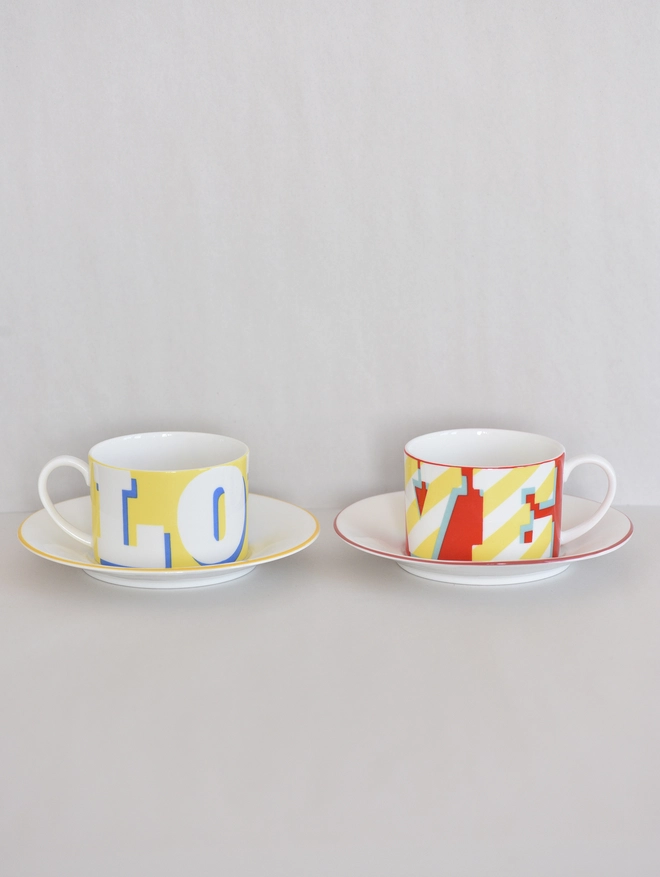 2 LOVE CUPS AND SAUCERS