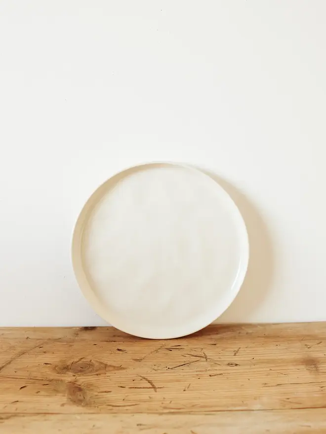 small stoneware plates (set of 2). a round plate in white.
