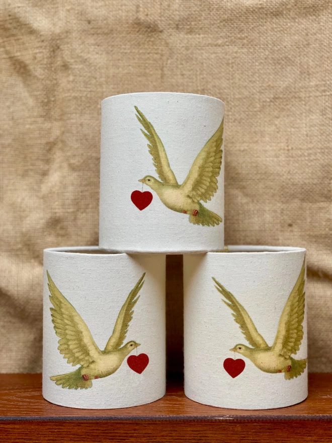 Candle holders with a dove carrying a red heart