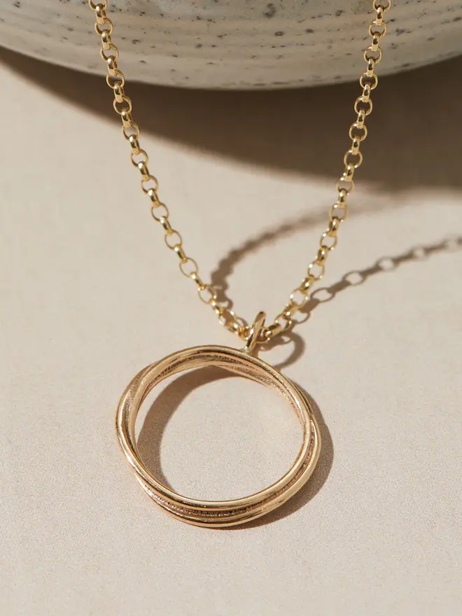 Dainty 9ct Gold Open Circle Necklace hanging over a bowl