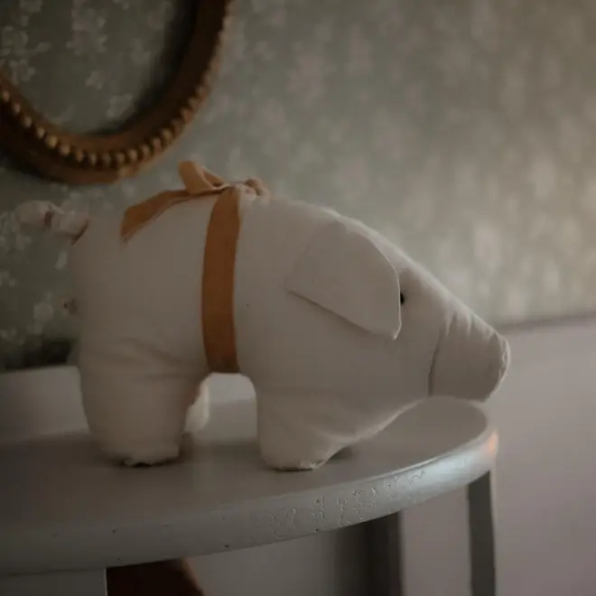 Plush Pig Stuffed Cotton Animal Toy, a stuffed pig toy in a decorated bedroom. 