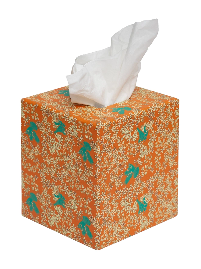 Corali Tissue Box Cover, a colourful and patterned tissue box sitting on a white surface against a plain backdrop. 
