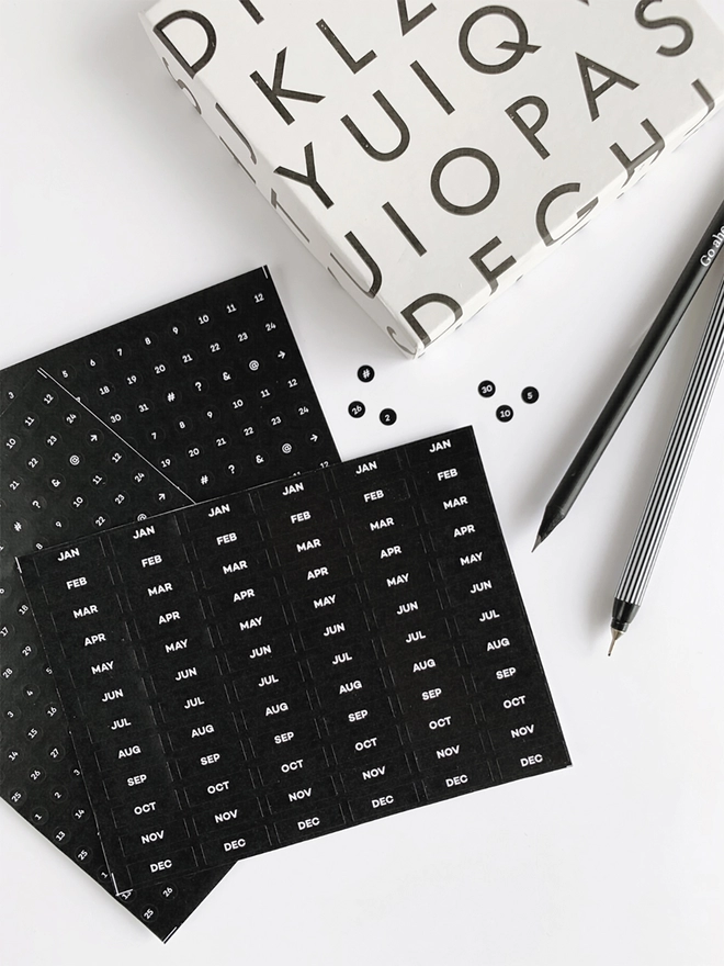 Open Undated Diary Dots Sticker Pack laid next to a black pencil and fineliner.