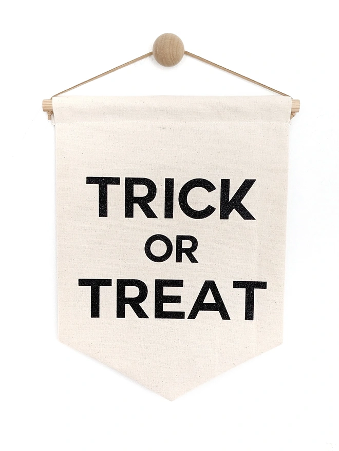 Trick or Treat reversable banner printed on a fabric hanging. Halloween