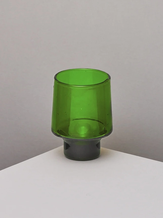 Tall Wine Glasses (Set Of 1 Or 4), a tall green wine glass sitting on a white counter top against a plain backdrop. 