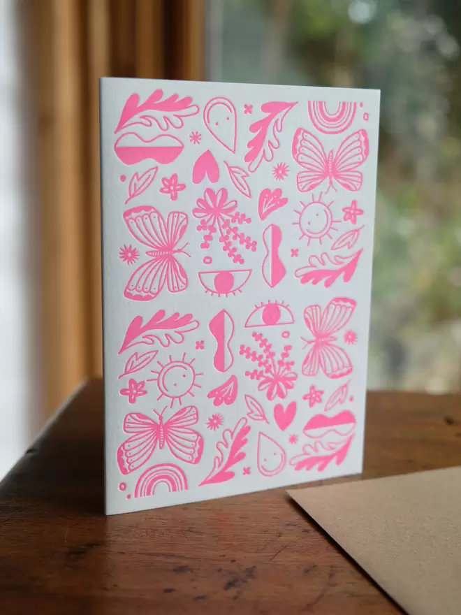 Pink shapes letterpress printed on a white A6 portrait card.