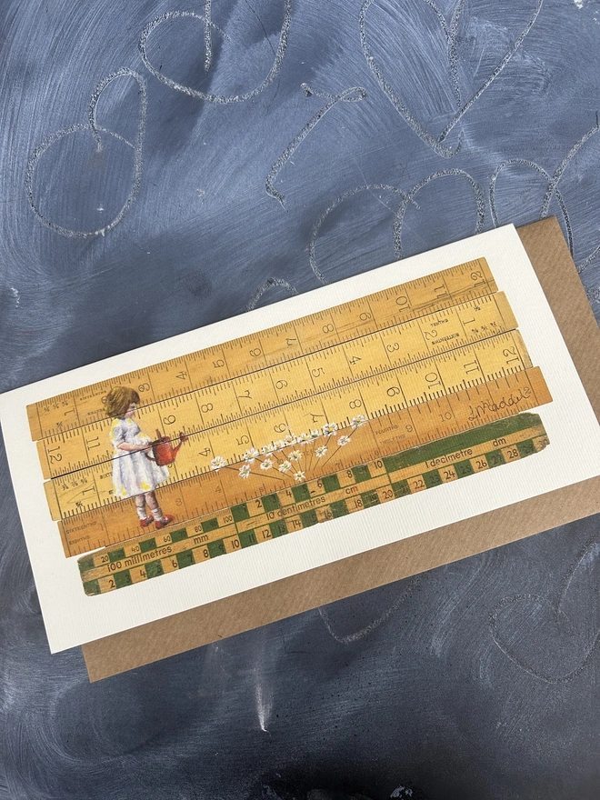 little girl wearing a white dress watering white flowers from a red watering can standing in front vintage school rulers