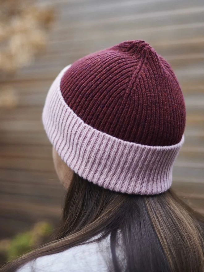Ribbed Lambswool Women's Beanie, a woman wearing a colourful beanie outdoors. 