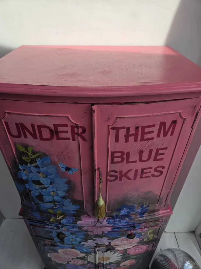 Painted vintage wooden cabinet with pink, blue and floral decoration