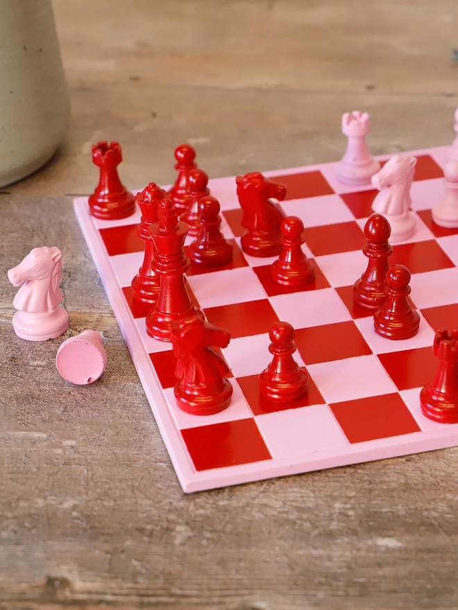 Handmade Jesmonite Chess Board, a handmade colourful chess board sitting on a wooden surface. 