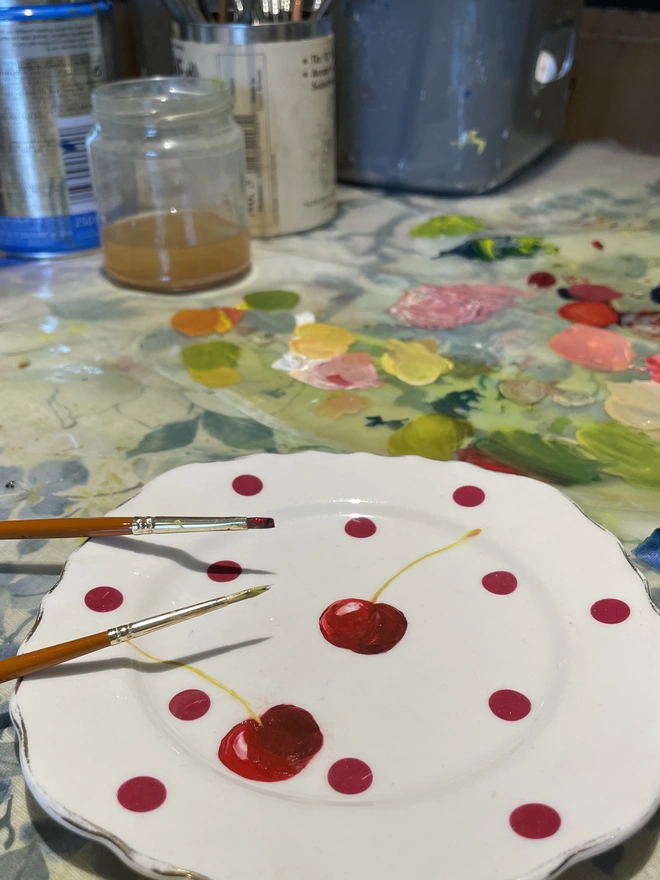 painting cherries on a plate